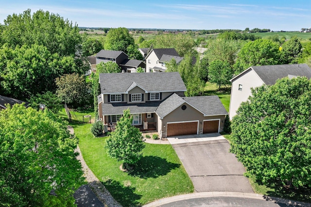 19883 Evensong Ct, Farmington, MN 55024 - view of front of home featuring an attached garage, concrete driveway, a front yard, a shingled roof, and stone siding
