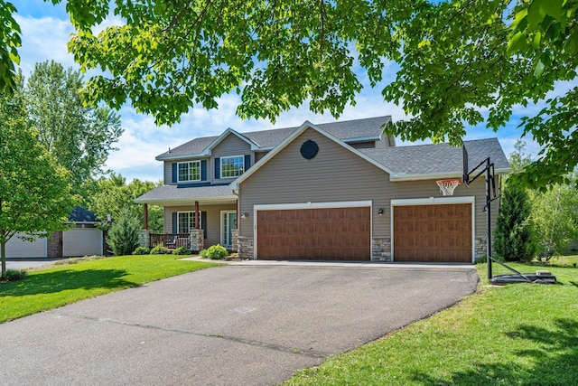 19883 Evensong Ct, Farmington, MN 55024 - view of front of property featuring a front yard, asphalt driveway, a garage, and stone siding