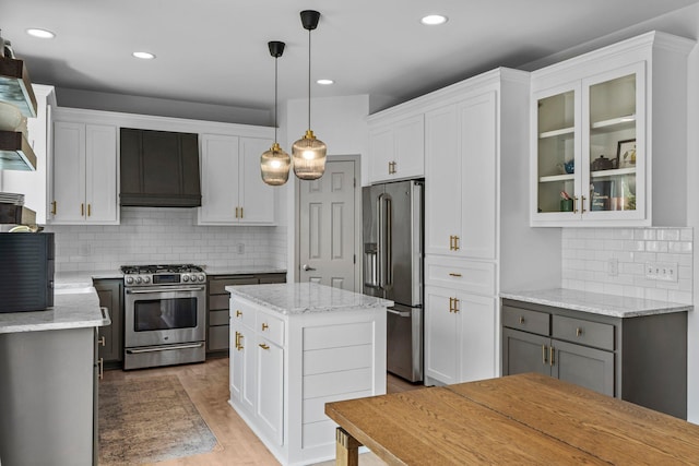 19883 Evensong Ct, Farmington, MN 55024 - kitchen with appliances with stainless steel finishes, white cabinetry, backsplash, glass insert cabinets, and recessed lighting