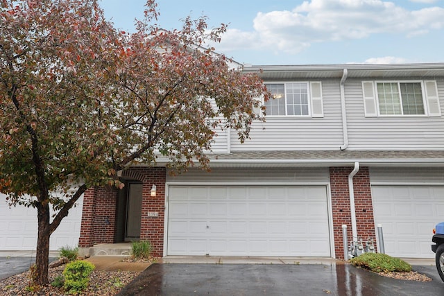 3394 Spring Glen Cir NW, Prior Lake, MN 55372 - townhome / multi-family property featuring brick siding, asphalt driveway, and a garage