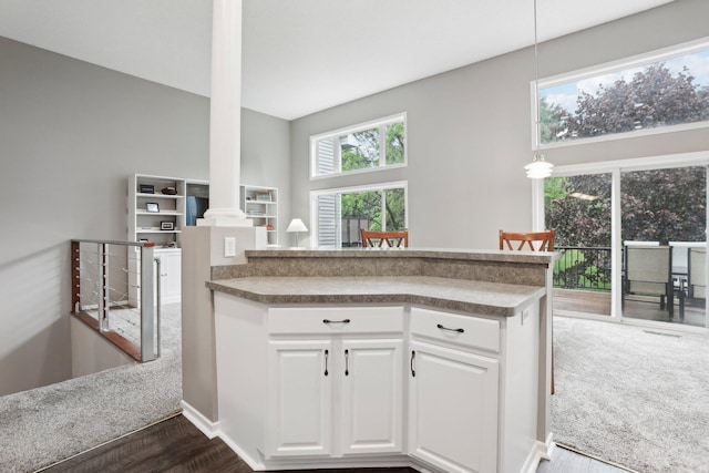 3394 Spring Glen Cir NW, Prior Lake, MN 55372 - kitchen featuring white cabinets, dark wood finished floors, ornate columns, a peninsula, and pendant lighting