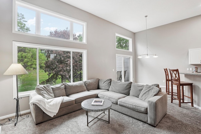 3394 Spring Glen Cir NW, Prior Lake, MN 55372 - living area with a towering ceiling, carpet flooring, healthy amount of natural light, and baseboards