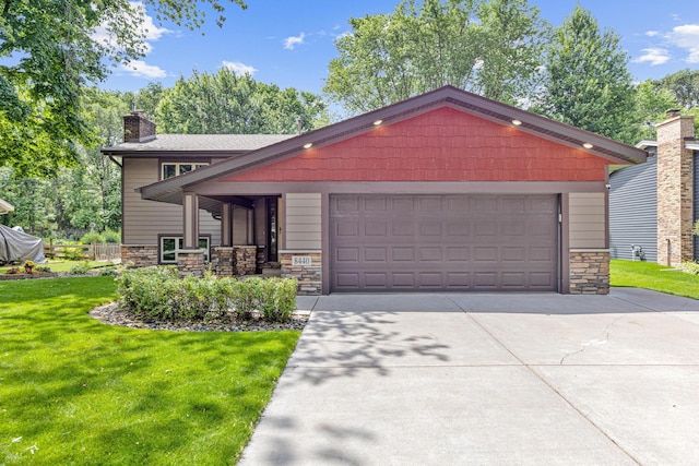 8440 Knollwood Dr, Mounds View, MN 55112 - view of front of home with stone siding, a front yard, a chimney, concrete driveway, and an attached garage