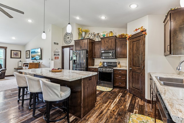 10798 Quiner Ave NW, Southside Twp, MN 55382 - kitchen with stainless steel appliances, a sink, dark brown cabinets, a kitchen island, and dark wood-style floors