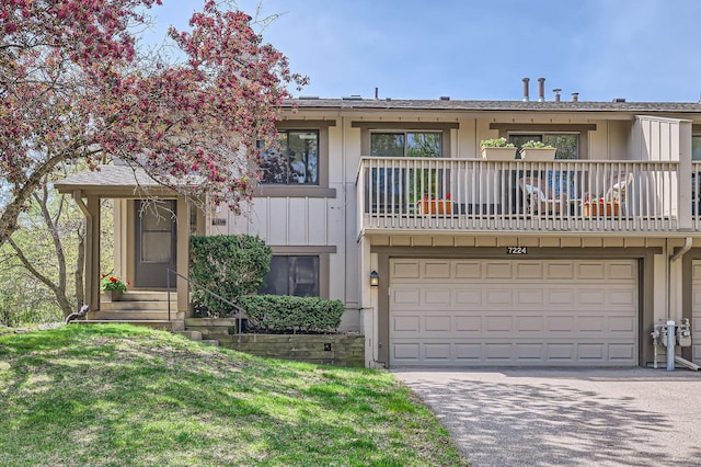 view of front of house with a balcony, a garage, and driveway
