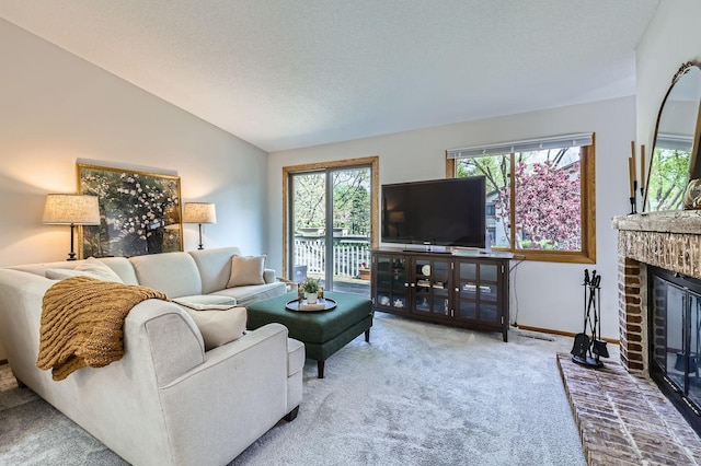 carpeted living area featuring lofted ceiling, a brick fireplace, baseboards, and a textured ceiling