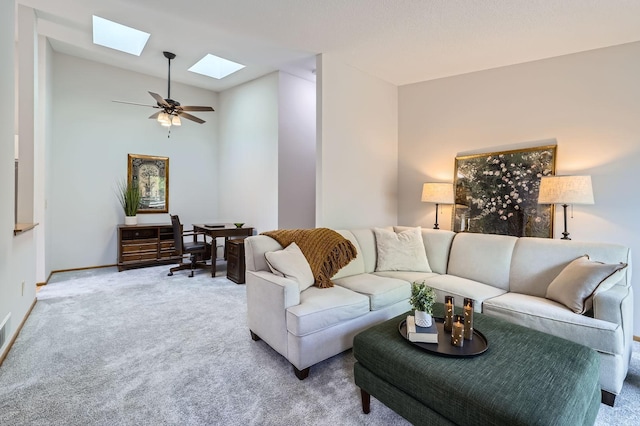 living room featuring a skylight, carpet flooring, lofted ceiling, a ceiling fan, and baseboards