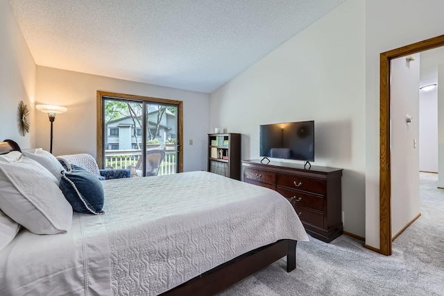 carpeted bedroom with lofted ceiling, access to outside, a textured ceiling, and baseboards