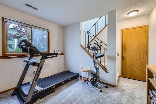 exercise area featuring carpet and baseboards