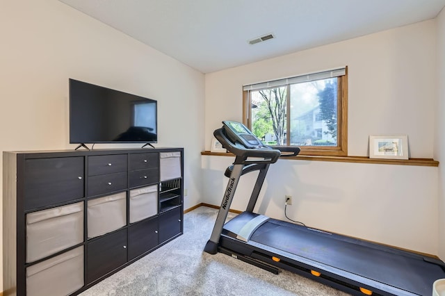 exercise room with carpet floors and baseboards