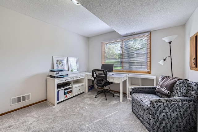 office featuring light carpet, a textured ceiling, and baseboards