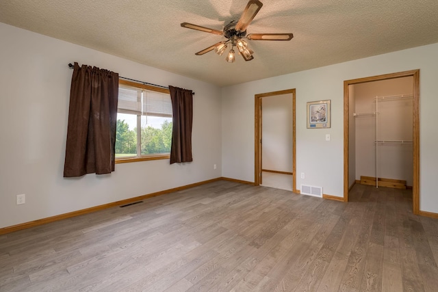 24058 610th Ave, Madison Lake, MN 56063 - unfurnished room featuring ceiling fan, wood finished floors, a textured ceiling, and baseboards