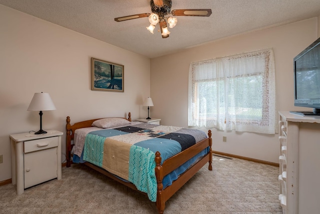 24058 610th Ave, Madison Lake, MN 56063 - bedroom featuring light carpet, a textured ceiling, baseboards, and ceiling fan