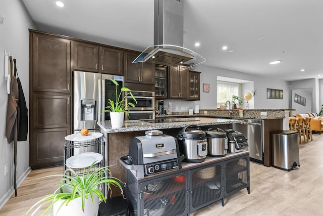 4014 River Valley Way, Eagan, MN 55122 - kitchen featuring appliances with stainless steel finishes, island range hood, a peninsula, dark brown cabinetry, and light wood-style floors