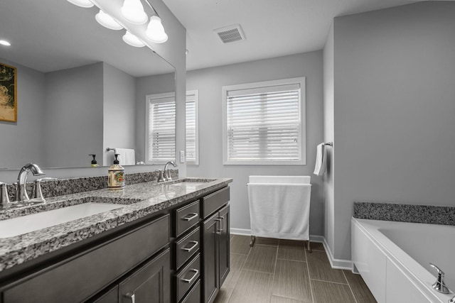 4014 River Valley Way, Eagan, MN 55122 - full bath featuring baseboards, double vanity, and a garden tub