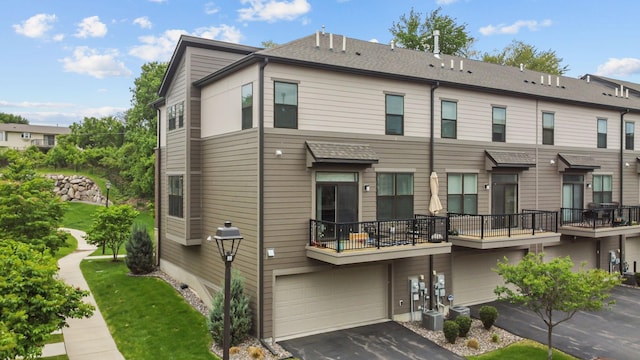 4014 River Valley Way, Eagan, MN 55122 - rear view of property featuring a garage, driveway, a balcony, and central AC unit