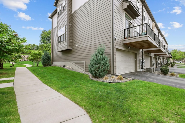 4014 River Valley Way, Eagan, MN 55122 - view of side of home with a balcony, a yard, central air condition unit, a garage, and asphalt driveway