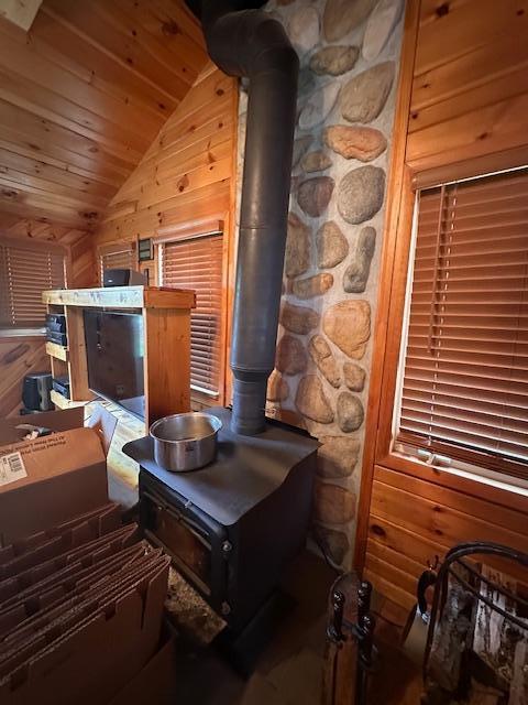 2377 Finn Bay Rd, Babbitt, MN 55706 - bedroom featuring vaulted ceiling, wood ceiling, wooden walls, and a wood stove