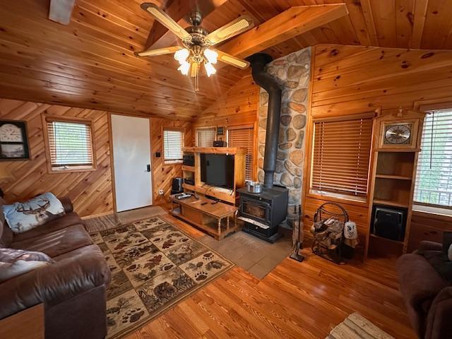 2377 Finn Bay Rd, Babbitt, MN 55706 - living room featuring a wood stove, wooden ceiling, lofted ceiling, healthy amount of natural light, and ceiling fan