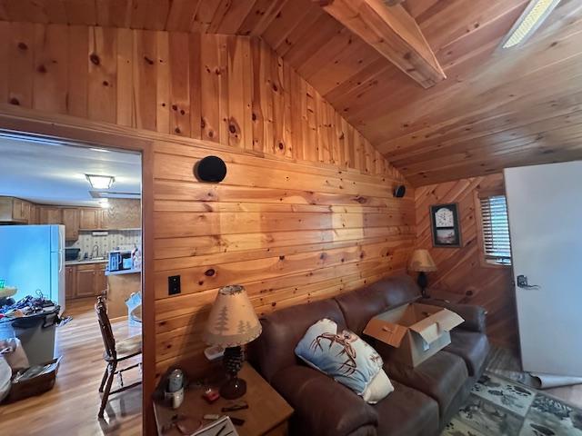 2377 Finn Bay Rd, Babbitt, MN 55706 - living area featuring vaulted ceiling, wooden ceiling, light wood-style flooring, and wood walls