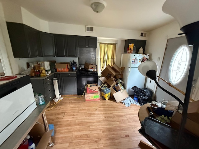 2812 6th Ave, Anoka, MN 55303 - kitchen with stove, freestanding refrigerator, light wood-type flooring, and dark cabinets