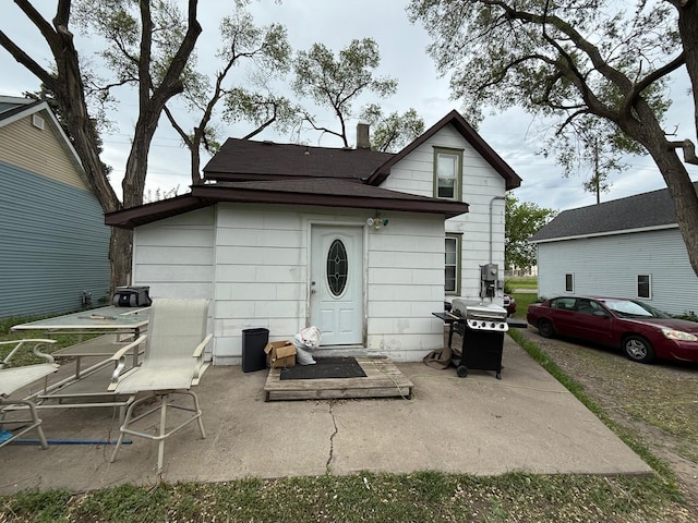 2812 6th Ave, Anoka, MN 55303 - back of house with a patio, a chimney, and roof with shingles