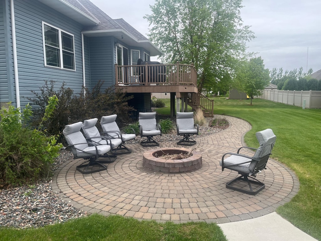 1808 4th St NE, Willmar, MN 56201 - view of patio featuring stairway, a fire pit, and a wooden deck