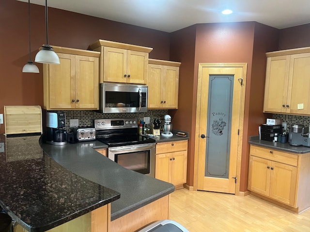 1808 4th St NE, Willmar, MN 56201 - kitchen featuring stainless steel appliances, light brown cabinets, a peninsula, backsplash, and recessed lighting