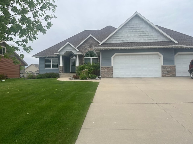 1808 4th St NE, Willmar, MN 56201 - craftsman inspired home with an attached garage, stone siding, driveway, a front yard, and roof with shingles