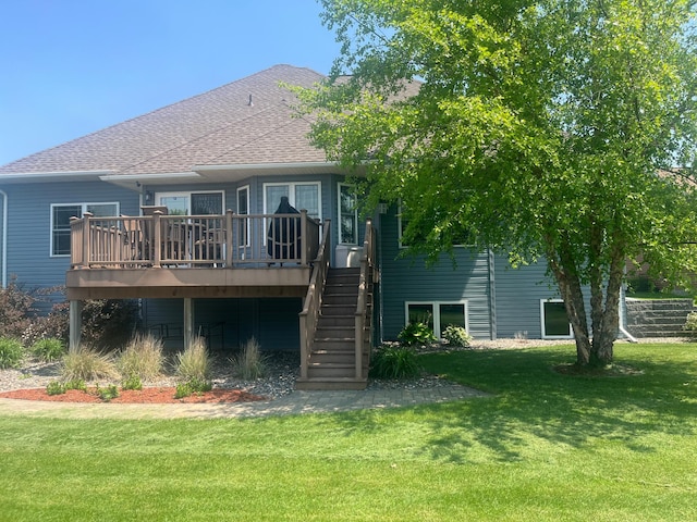 1808 4th St NE, Willmar, MN 56201 - rear view of property featuring a deck, a lawn, stairs, and a shingled roof