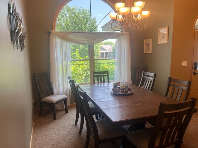 1808 4th St NE, Willmar, MN 56201 - dining room featuring light colored carpet, a chandelier, and baseboards