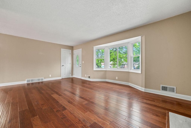 3013 64th Ave N, Brooklyn Center, MN 55429 - empty room featuring hardwood / wood-style flooring, baseboards, and a textured ceiling
