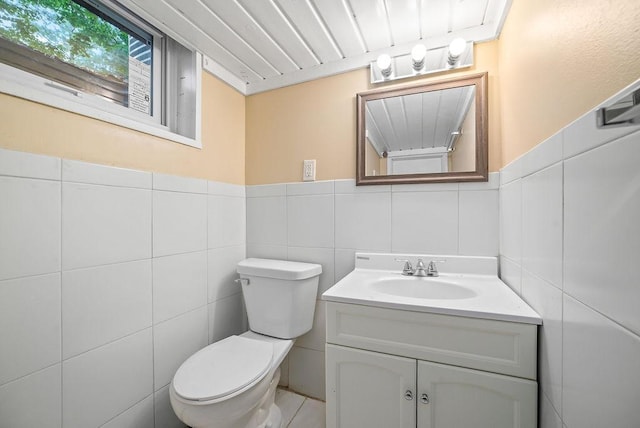 3013 64th Ave N, Brooklyn Center, MN 55429 - bathroom with toilet, vanity, and tile walls
