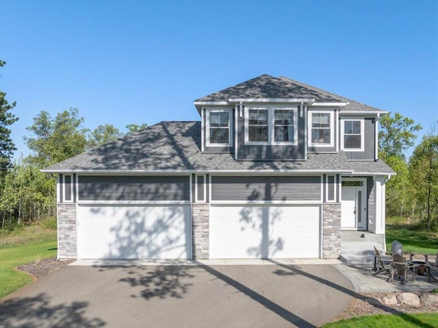16524 Piper Ln, Brainerd, MN 56401 - view of front of property featuring stone siding, roof with shingles, and driveway
