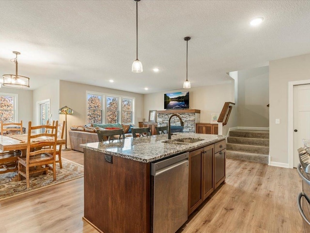 16524 Piper Ln, Brainerd, MN 56401 - kitchen featuring dishwasher, a sink, open floor plan, a textured ceiling, and a fireplace