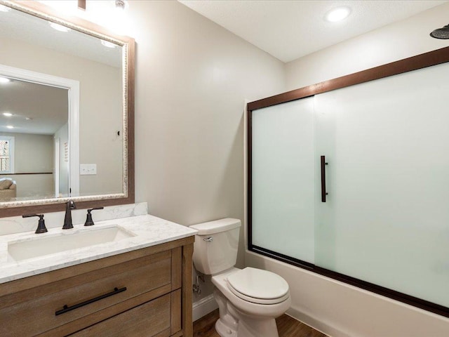 16524 Piper Ln, Brainerd, MN 56401 - full bath with toilet, vanity, shower / bath combination with glass door, wood finished floors, and recessed lighting