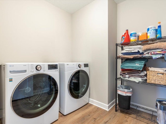 16524 Piper Ln, Brainerd, MN 56401 - washroom featuring independent washer and dryer, light wood-style flooring, and baseboards