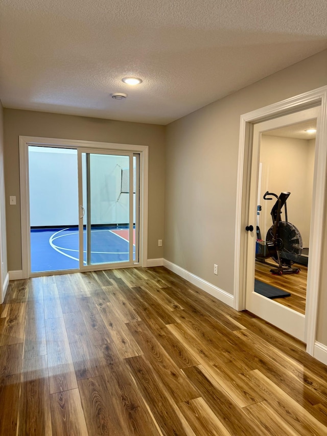 16524 Piper Ln, Brainerd, MN 56401 - spare room featuring wood finished floors, baseboards, and a textured ceiling
