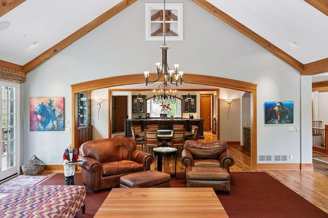 2442 Meeting St, Minnetonka, MN 55391 - living room featuring a chandelier, high vaulted ceiling, beam ceiling, wood finished floors, and baseboards