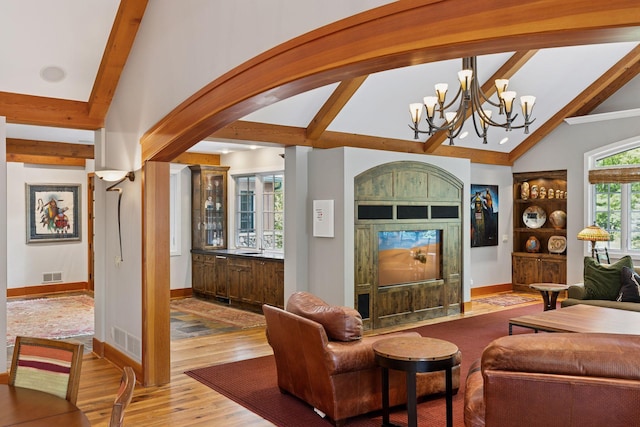 2442 Meeting St, Minnetonka, MN 55391 - living room with light wood-style floors, a chandelier, and baseboards
