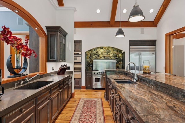 2442 Meeting St, Minnetonka, MN 55391 - kitchen with a sink, premium appliances, light wood finished floors, beam ceiling, and pendant lighting