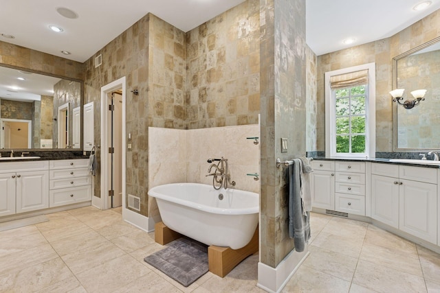 2442 Meeting St, Minnetonka, MN 55391 - full bath with tile walls, a stall shower, a soaking tub, two vanities, and tile patterned floors