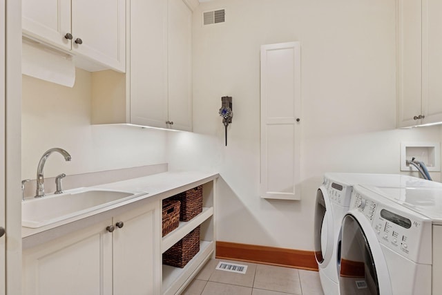 2442 Meeting St, Minnetonka, MN 55391 - laundry area with cabinet space, washing machine and dryer, light tile patterned floors, and baseboards
