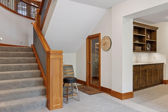 2442 Meeting St, Minnetonka, MN 55391 - stairs featuring carpet floors, bar with sink, baseboards, and lofted ceiling