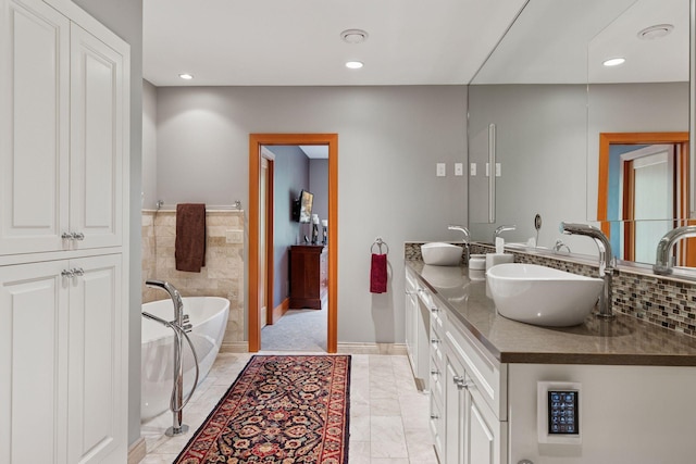2442 Meeting St, Minnetonka, MN 55391 - bathroom featuring double vanity, a freestanding tub, recessed lighting, and baseboards
