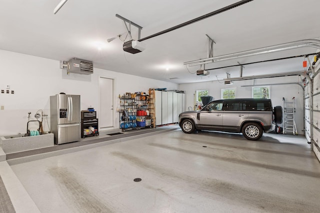 2442 Meeting St, Minnetonka, MN 55391 - garage featuring stainless steel fridge, a garage door opener, and a heating unit