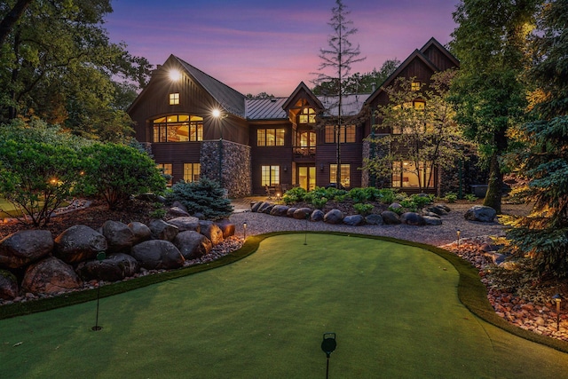 2442 Meeting St, Minnetonka, MN 55391 - back of property with a putting area, a balcony, a standing seam roof, and metal roof