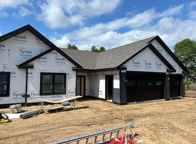 unfinished property featuring a shingled roof
