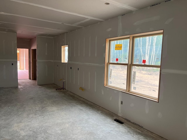 unfurnished room featuring concrete floors