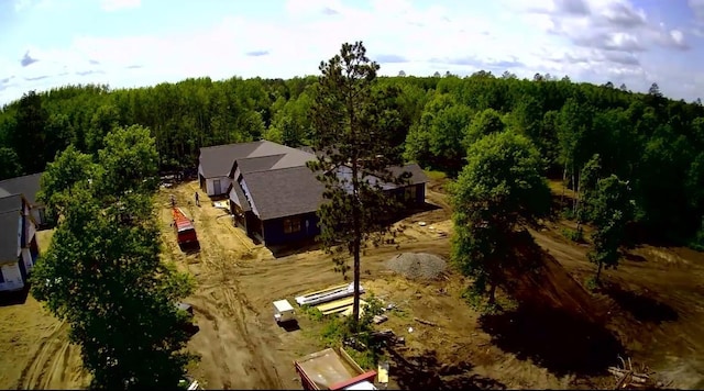 aerial overview of property's location featuring a heavily wooded area